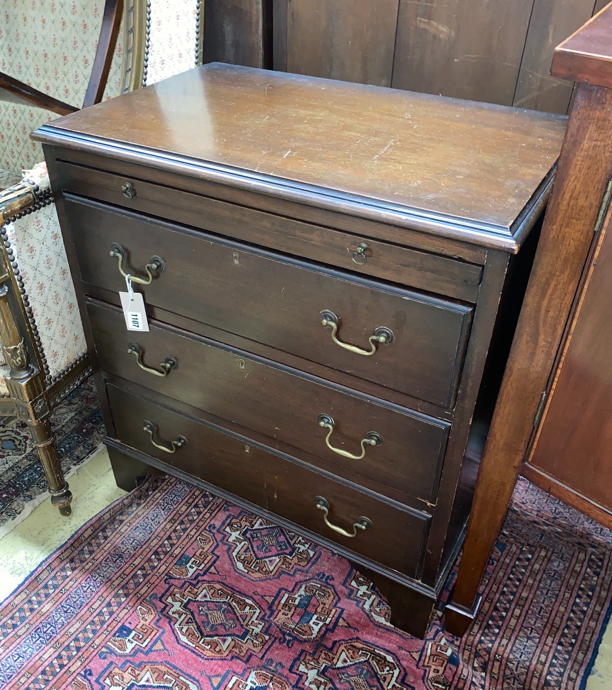 A small George III style mahogany chest three long drawers, with brushing slide, width 68cm, depth 43cm, height 75cm